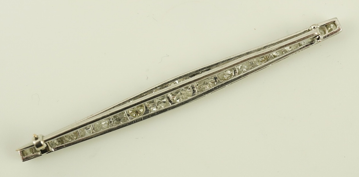 A 1920's platinum? and nineteen millegrain set graduated diamond bar brooch, 59mm, gross weight 4.6 grams. Condition - fair to good